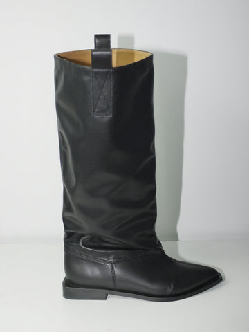 Original Ganni black leather knee-high boots with round toe and flat sole, timeless Scandinavian design, styled with mini skirt and layered look, perfect for transitional seasons.