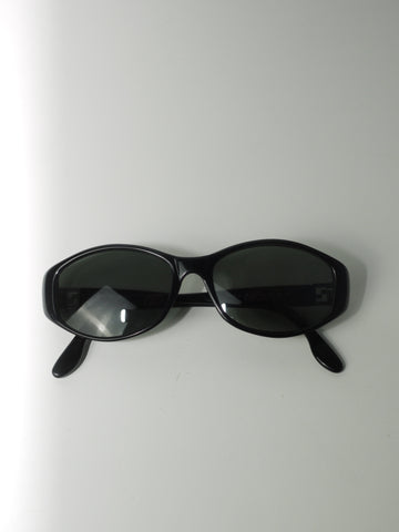 Vintage black Fendi sunglasses with slim oval frame, 90s Y2K designer eyewear style, minimalist retro aesthetic, unisex fashion accessory on white background.