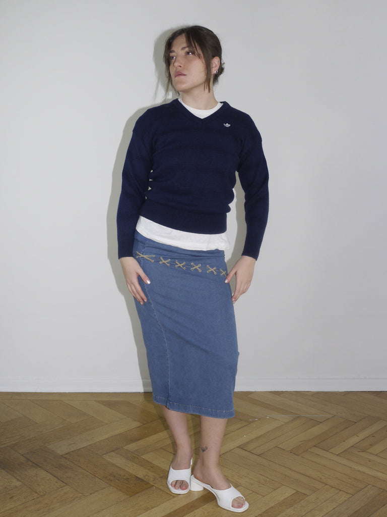 Vintage Adidas navy pullover with white logo stitching on the chest. Classic sportswear look without side stripes, slightly cropped fit, styled with a Y2K-style denim midi skirt.