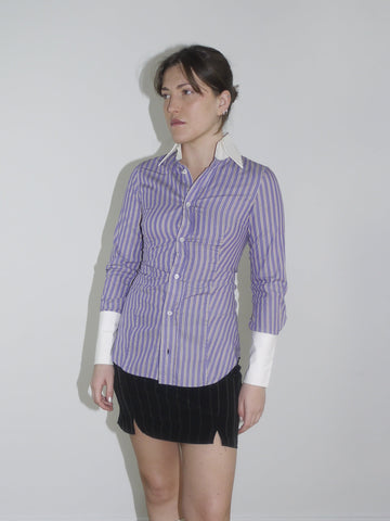 Fitted striped button-up shirt in purple with contrast white cuffs and collar. Sharp silhouette, early 2000s Dsquared vibes. Styled with a pinstripe mini skirt and knee-high boots.