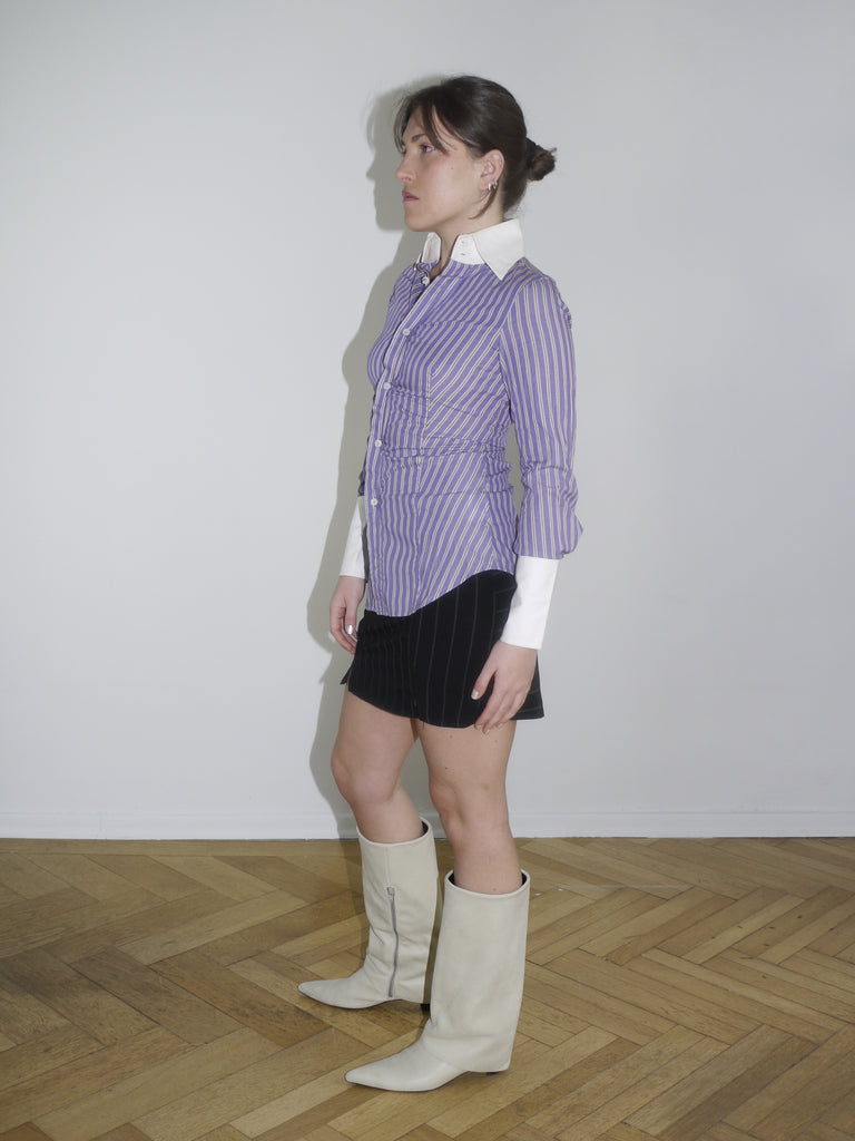 Fitted striped button-up shirt in purple with contrast white cuffs and collar. Sharp silhouette, early 2000s Dsquared vibes. Styled with a pinstripe mini skirt and knee-high boots.