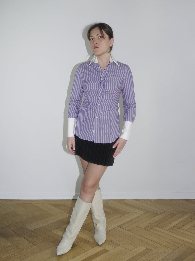 Fitted striped button-up shirt in purple with contrast white cuffs and collar. Sharp silhouette, early 2000s Dsquared vibes. Styled with a pinstripe mini skirt and knee-high boots.