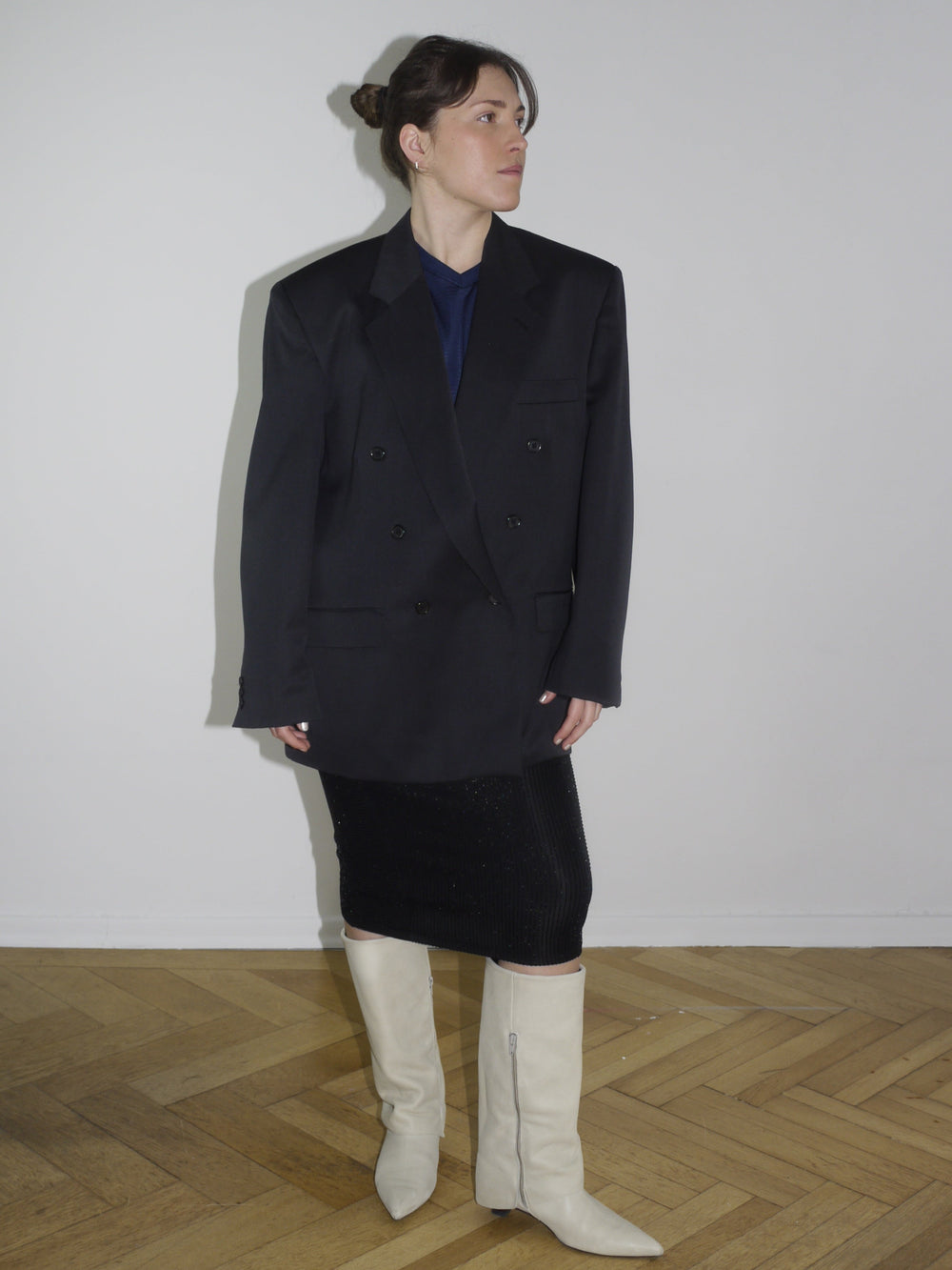 Vintage black oversized blazer with double-breasted buttons and sharp shoulders, styled with a midi pencil skirt and off-white boots. Inspired by Maison Margiela and Dries Van Noten tailoring.