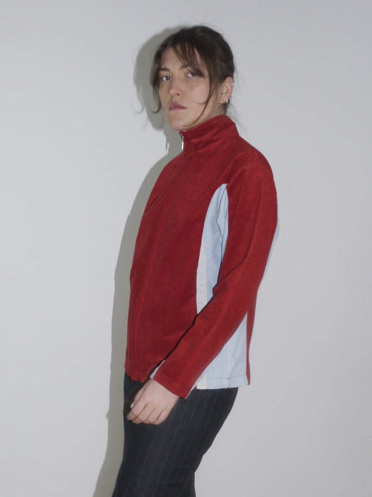 Vintage red zip-up fleece jacket with white contrast panels – retro sporty look inspired by early 2000s streetwear, similar to pieces by Diesel and Lotto.
