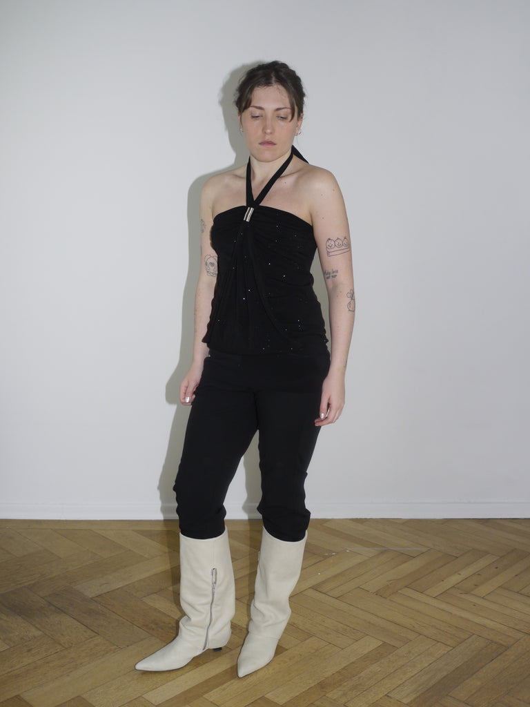 Side profile showing two-piece outfit: black glittery halter top and tight low-rise trousers – inspired by Diesel and club-era silhouettes.