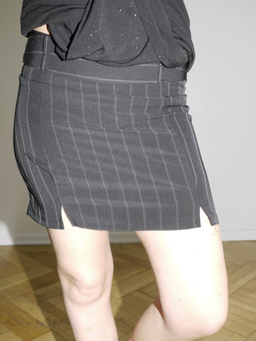 Black vintage mini skirt with white pinstripes and double front slits. Fitted silhouette, business-core meets Y2K minimal. Inspired by Diesel and Dsquared aesthetics