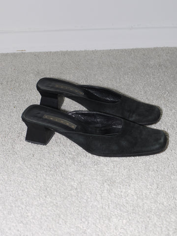 Vintage black suede slingback heels with square toe and low block heel, featuring a subtle logo detail on the insole from the brand Paloma.